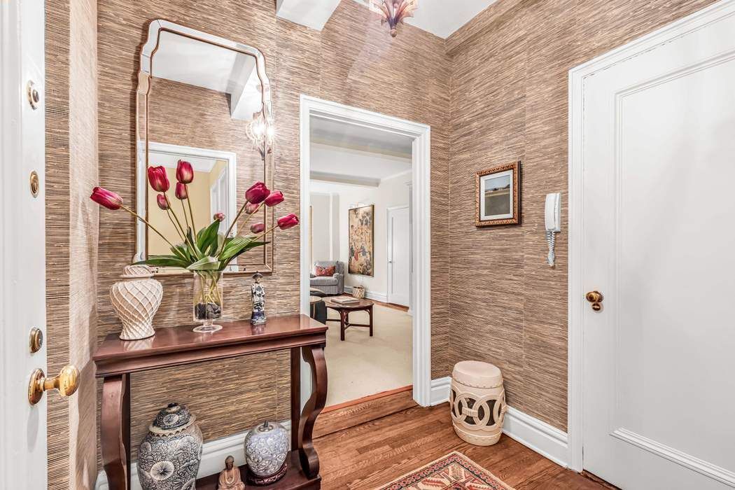 135 East 74th Street, Unit 6C Manhattan, NY 10021 - Photo 3 of 8 a bath room with a toilet and a potted plant