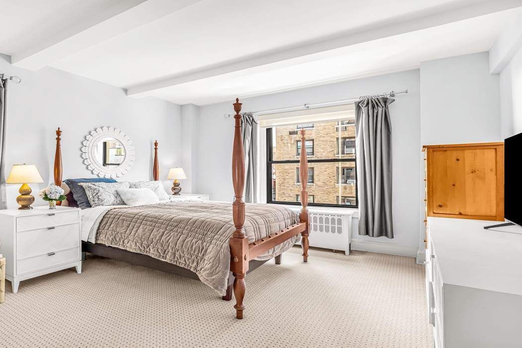 135 East 74th Street, Unit 6C Manhattan, NY 10021 - Photo 5 of 8 a spacious bedroom with a bed and a large window