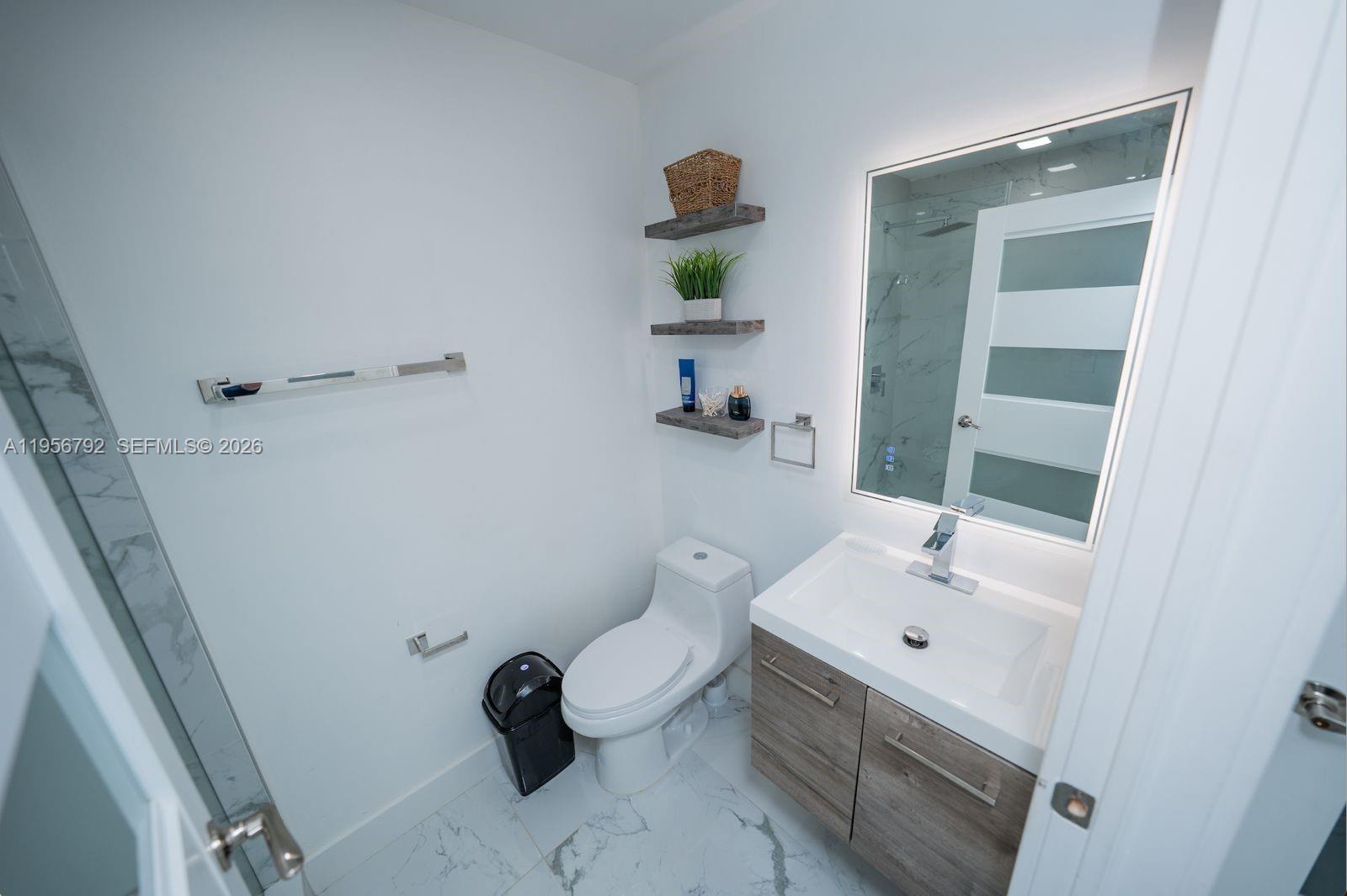 17404 Southwest 142nd Place Miami, FL 33177 - Photo 11 of 29 a bathroom with a sink mirror and toilet