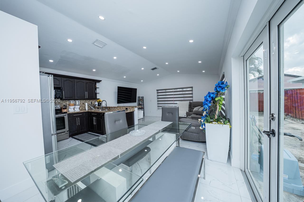 17404 Southwest 142nd Place Miami, FL 33177 - Photo 2 of 29 a large white kitchen with a large window a refrigerator and a stove