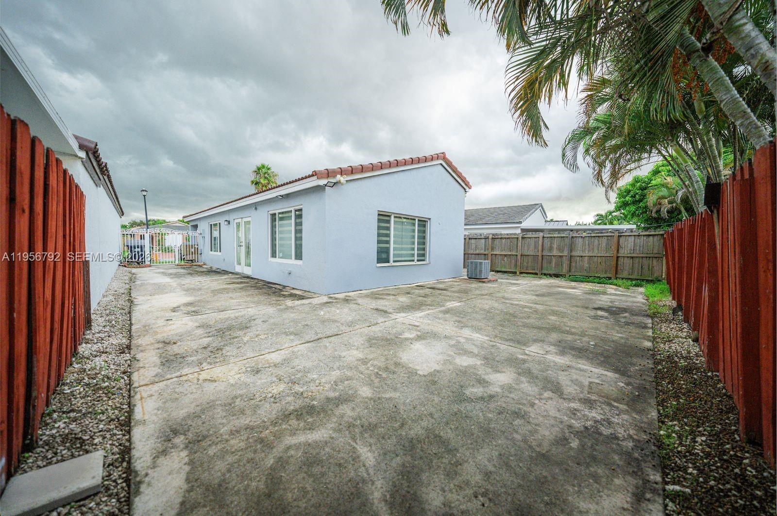 17404 Southwest 142nd Place Miami, FL 33177 - Photo 21 of 29 a view of backyard with a garden and palm trees