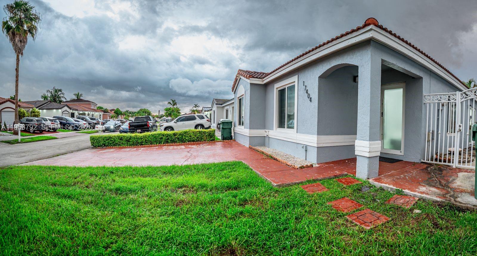 17404 Southwest 142nd Place Miami, FL 33177 - Photo 29 of 29 a front view of a house with yard and glass windows