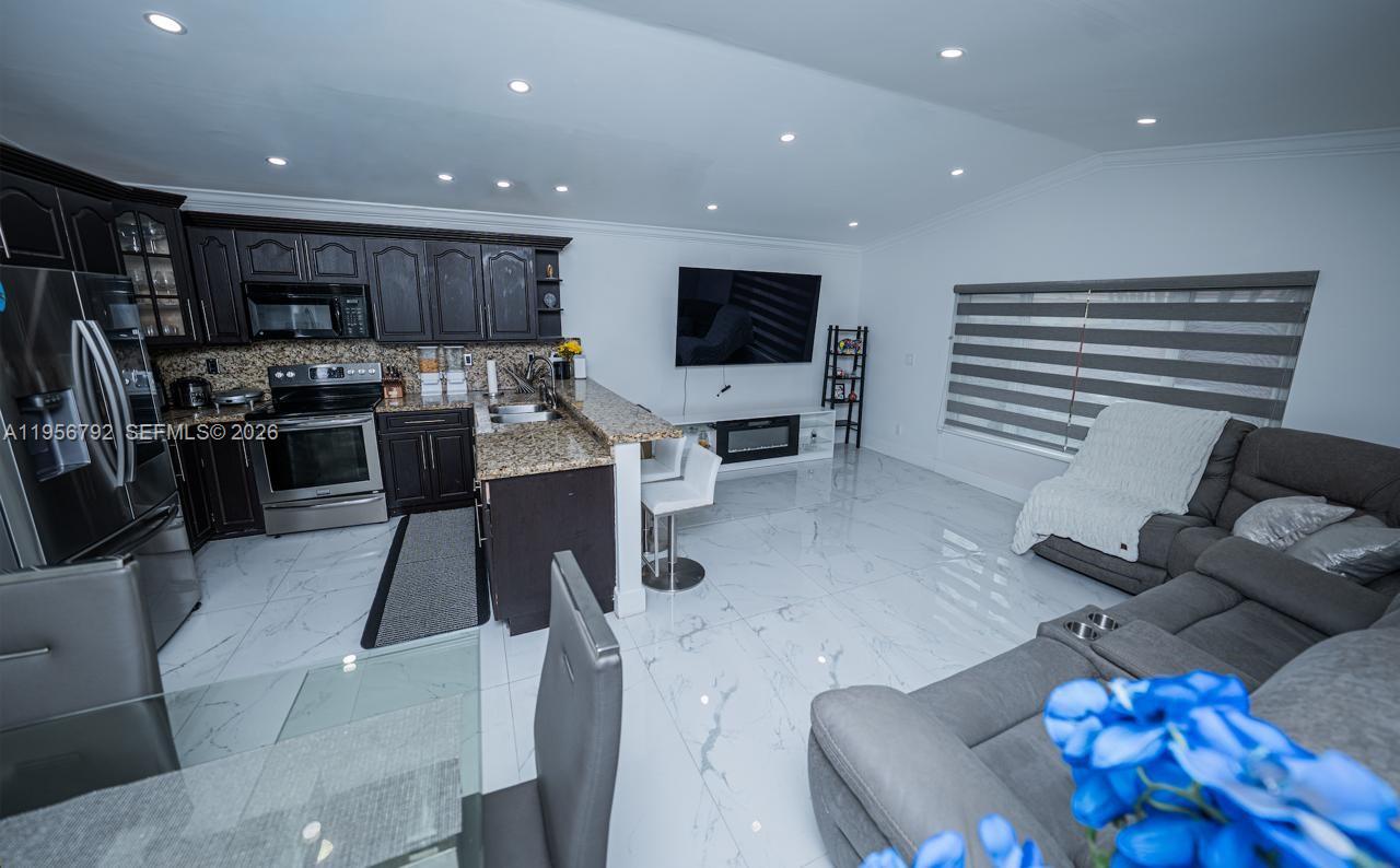 17404 Southwest 142nd Place Miami, FL 33177 - Photo 3 of 29 a living room with furniture and a flat screen tv