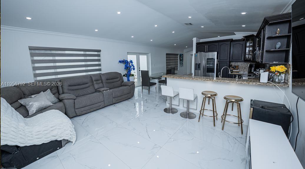 17404 Southwest 142nd Place Miami, FL 33177 - Photo 8 of 29 a living room with furniture and kitchen view