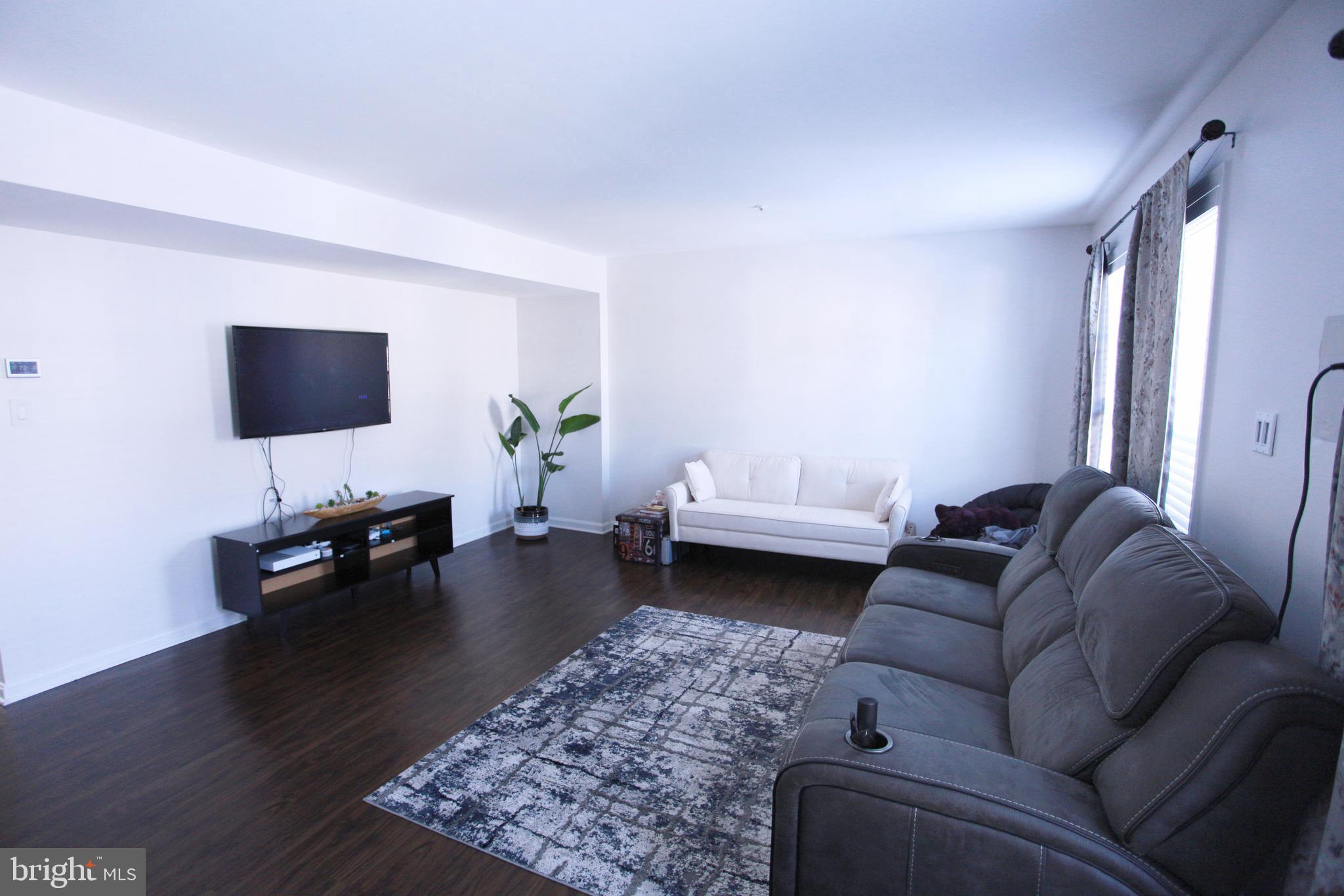 580 Primus Court Frederick, MD 21703 - Photo 2 of 14 a living room with furniture and a flat screen tv