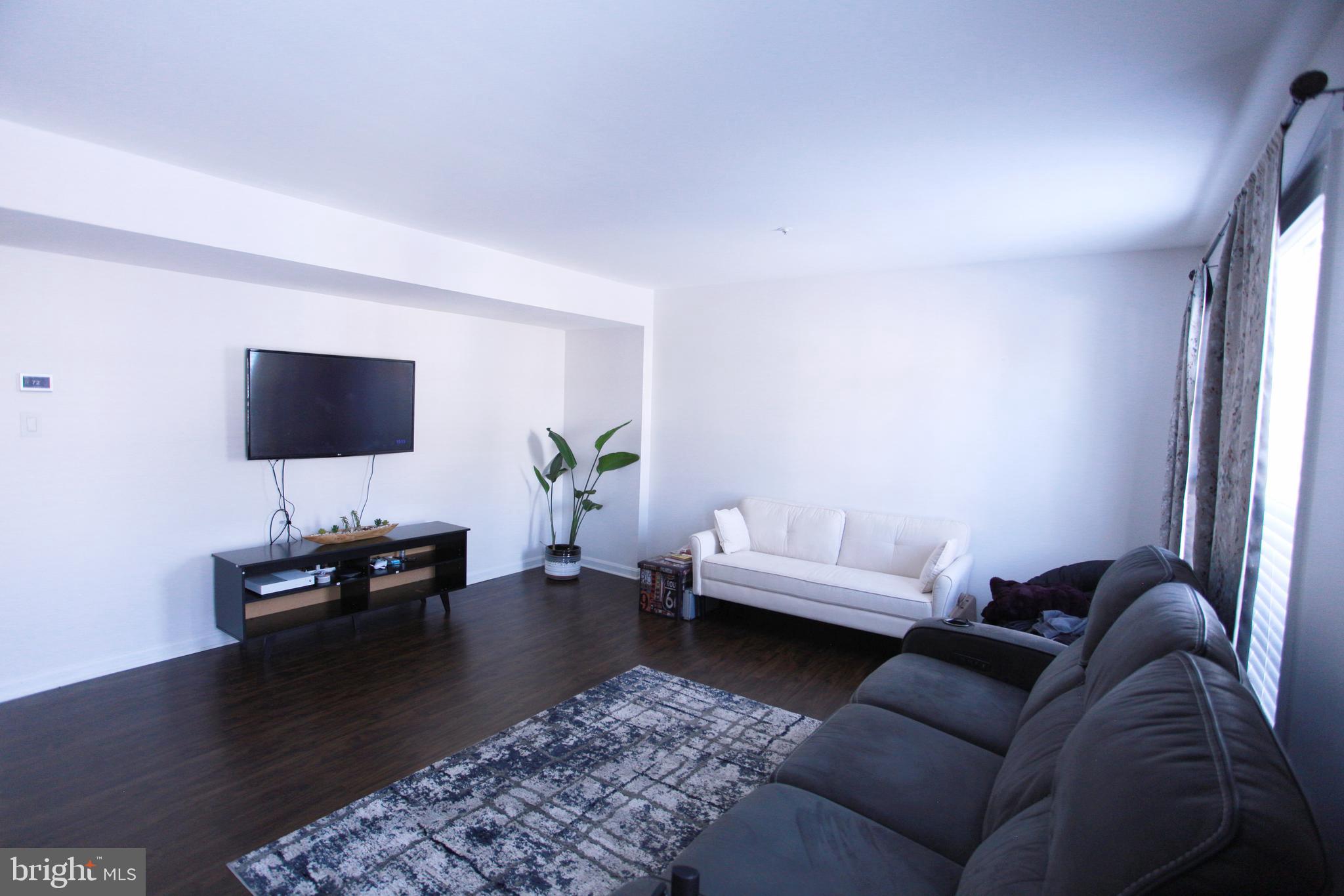 580 Primus Court Frederick, MD 21703 - Photo 3 of 14 a living room with furniture and a flat screen tv