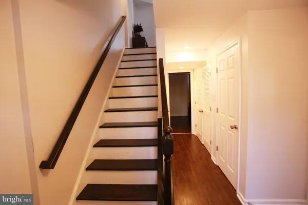 a view of entryway with wooden floor and stairs