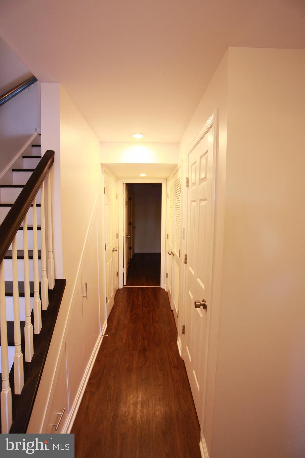 580 Primus Court Frederick, MD 21703 - Photo 5 of 14 a view of a hallway with wooden floor and staircase
