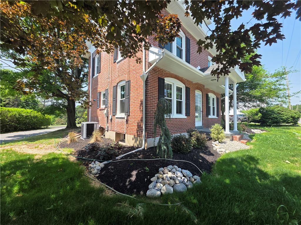 A classic brick facade with well-maintained landscaping and a welcoming covered entrance.