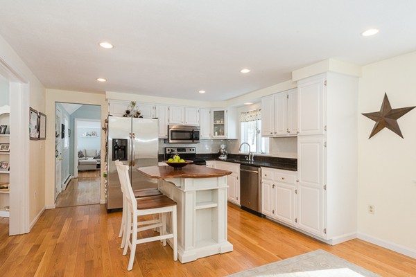 3 Pingree Farm Road Georgetown, MA 01833 - Photo 12 of 28 a kitchen with white cabinets and stainless steel appliances