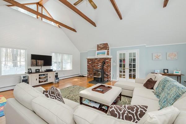 3 Pingree Farm Road Georgetown, MA 01833 - Photo 10 of 28 a living room with furniture a flat screen tv and a large window