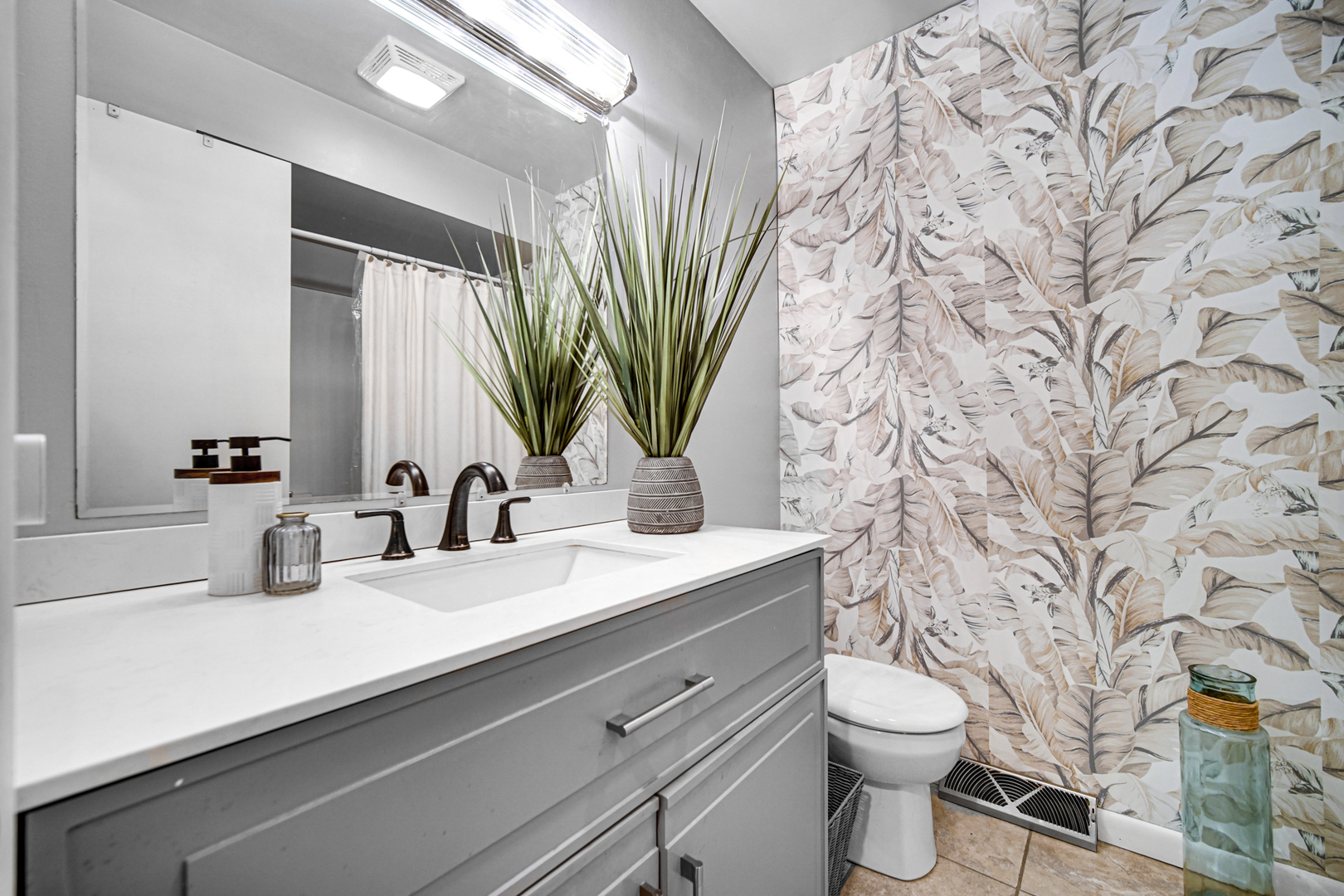 17509 Maple Avenue Lansing, IL 60438 - Photo 11 of 27 a bathroom with a granite countertop sink a toilet and a mirror