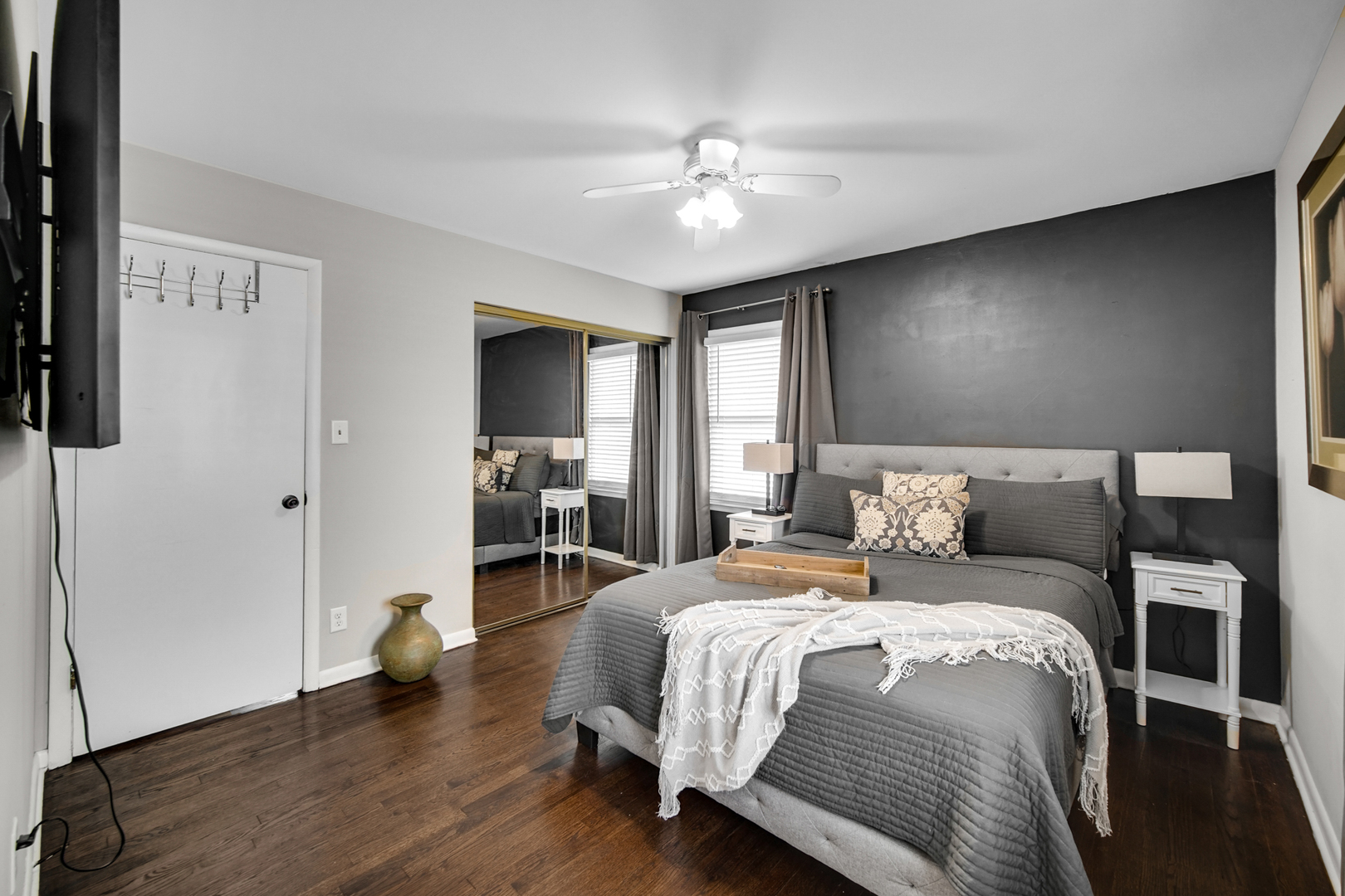 17509 Maple Avenue Lansing, IL 60438 - Photo 13 of 27 a bedroom with a large bed and a chandelier