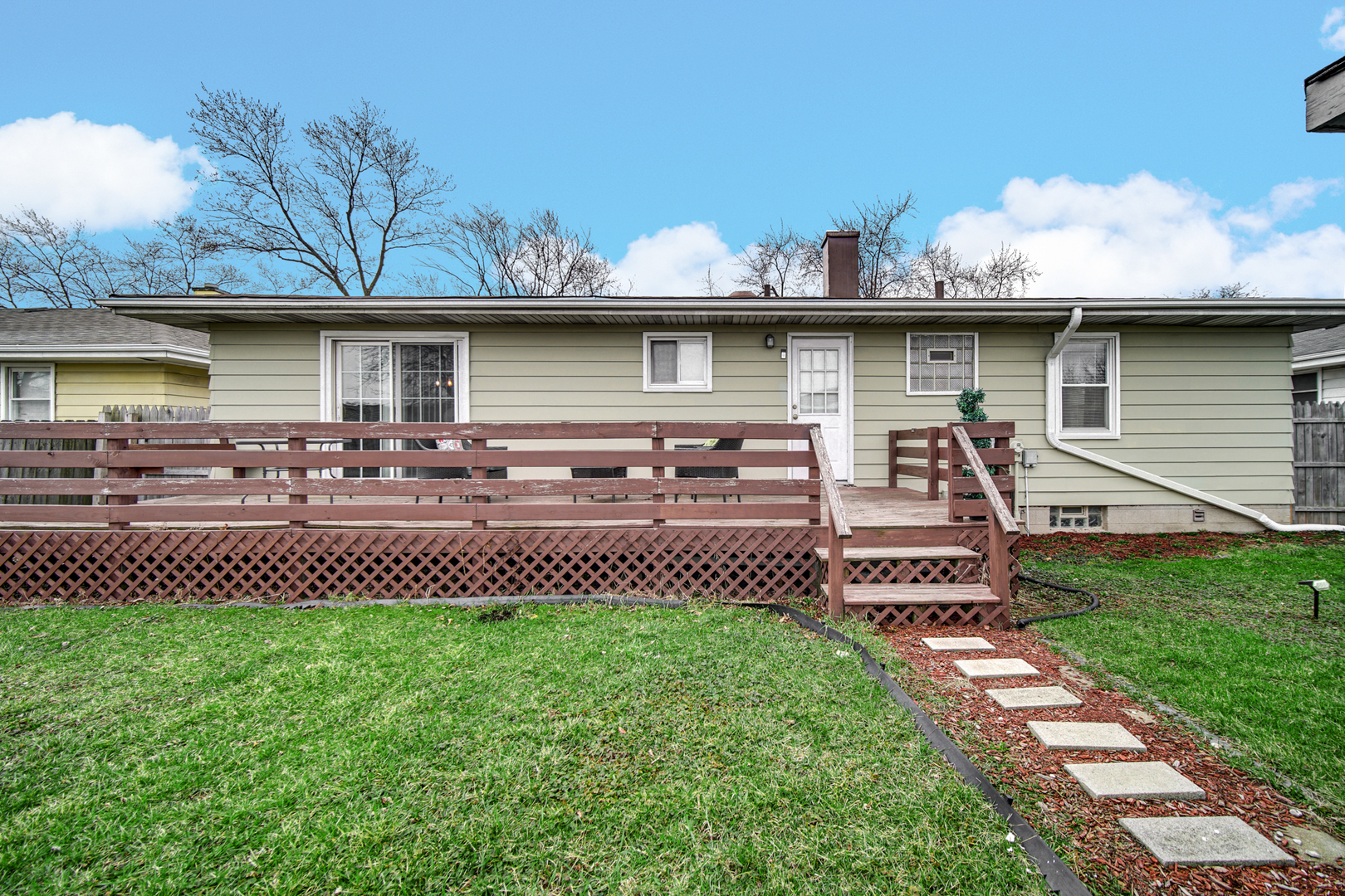 17509 Maple Avenue Lansing, IL 60438 - Photo 23 of 27 a front view of a house with a garden and plants