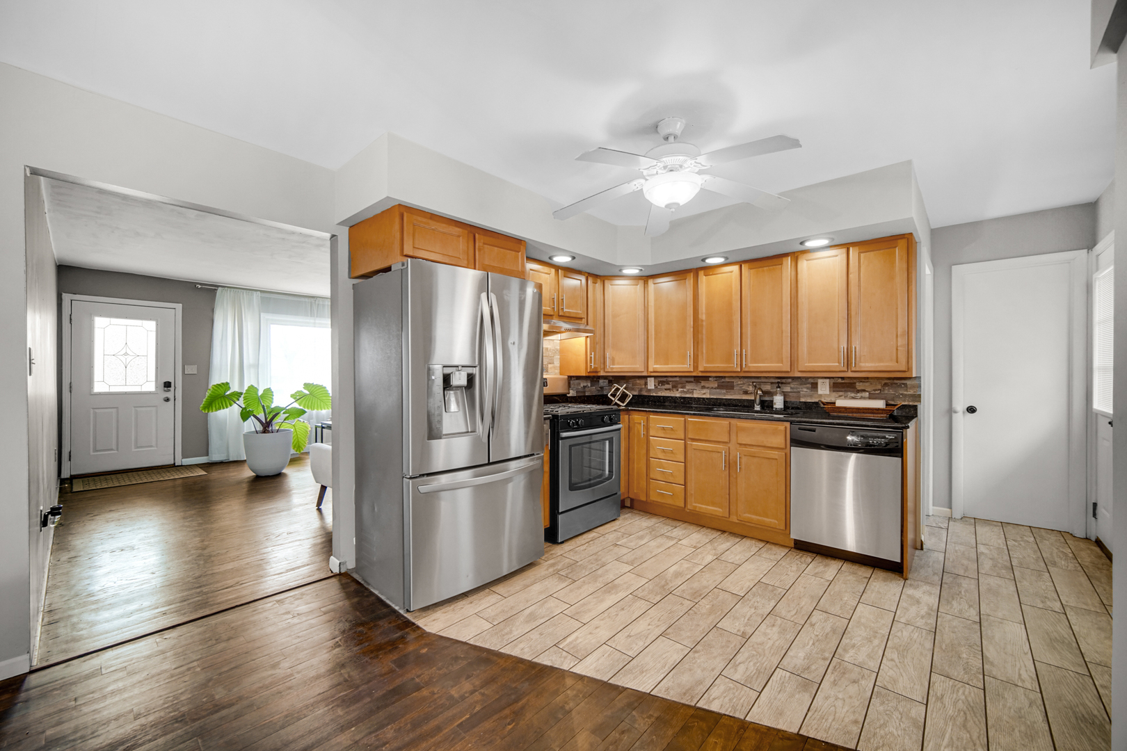 17509 Maple Avenue Lansing, IL 60438 - Photo 3 of 27 a kitchen with a refrigerator and a stove top oven