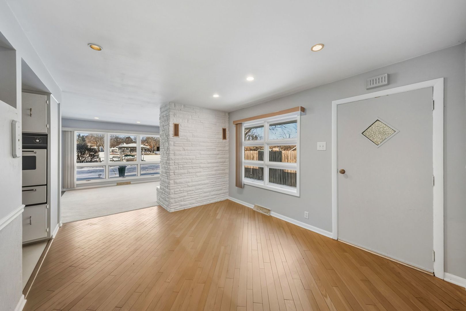 1515 North River Road McHenry, IL 60051 - Photo 18 of 27 a view of a big room with wooden floor and windows