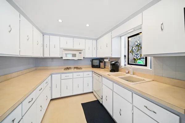 a kitchen with granite countertop a sink and cabinets