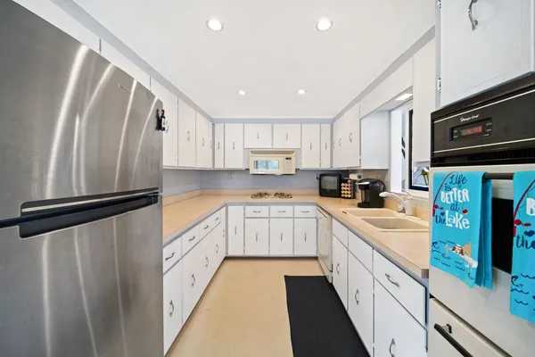 a kitchen with stainless steel appliances granite countertop a refrigerator sink and cabinets