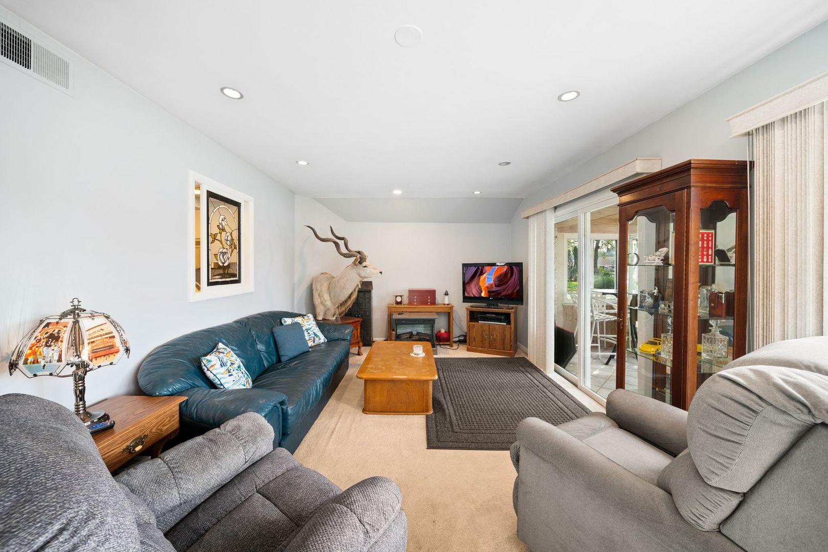 1515 North River Road McHenry, IL 60051 - Photo 5 of 27 a living room with furniture and a flat screen tv