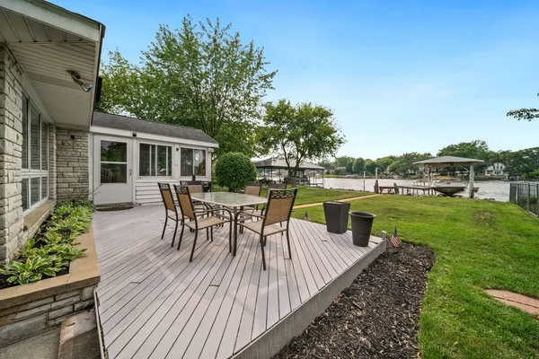 a view of a house with backyard and sitting area