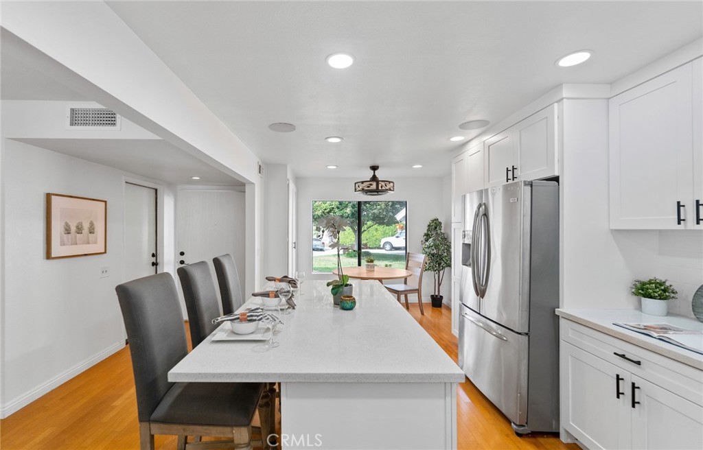 7 Boone Irvine, CA 92620 - Photo 15 of 38 a kitchen with stainless steel appliances granite countertop a refrigerator a sink a stove a dining table and chairs