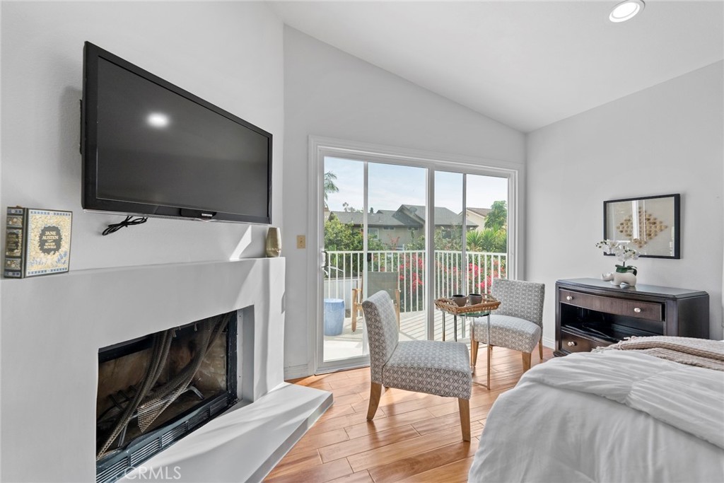 7 Boone Irvine, CA 92620 - Photo 22 of 38 a living room with furniture a flat screen tv and a fireplace