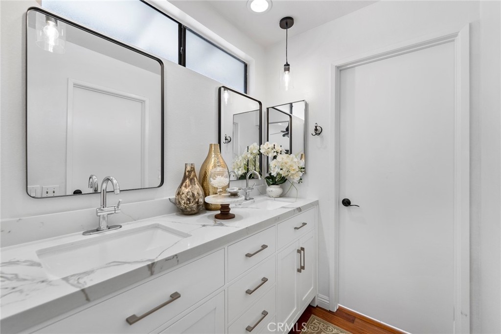 7 Boone Irvine, CA 92620 - Photo 25 of 38 a bathroom with double vanity sink and a mirror