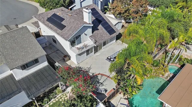 an aerial view of a house with a yard