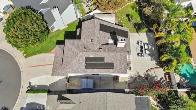 an aerial view of a house with a yard and sitting area
