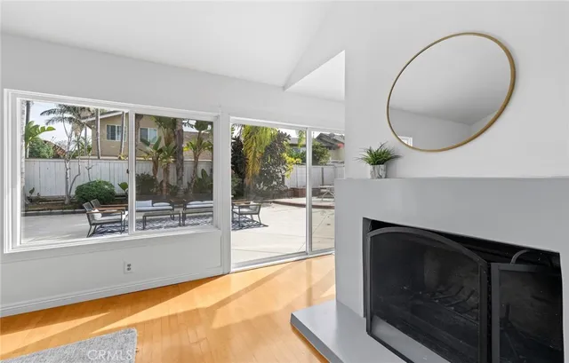 a living room with a fireplace and a floor to ceiling window
