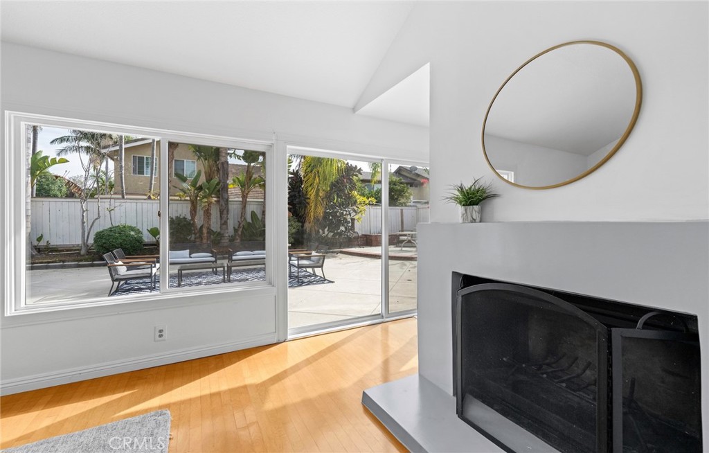 7 Boone Irvine, CA 92620 - Photo 8 of 38 a living room with a fireplace and a floor to ceiling window