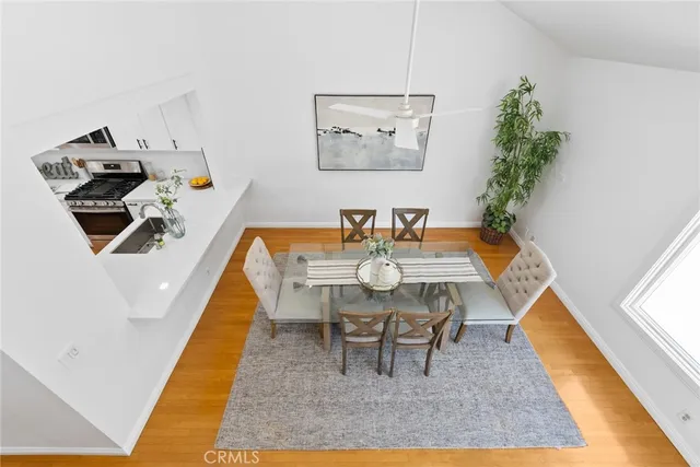 a dining room with furniture and wooden floor