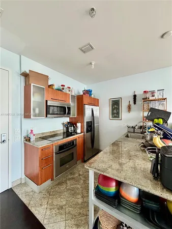 a kitchen with stainless steel appliances granite countertop a stove and a refrigerator