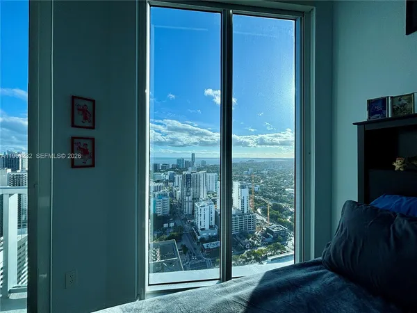 a view of a room that has a bed