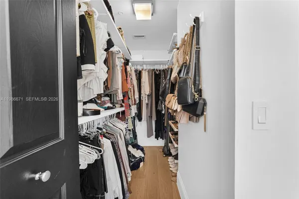 a view of walk in closet with clothes