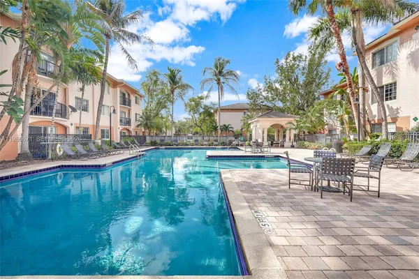 a swimming pool with outdoor seating and yard
