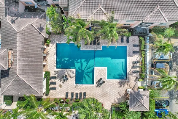 an aerial view of a house with a yard and potted plants