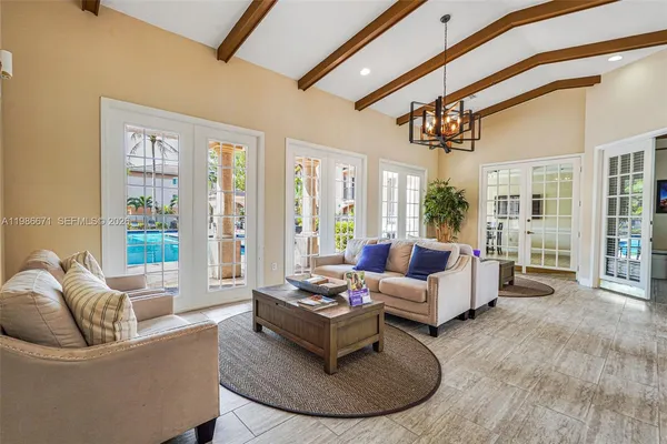 a living room with furniture and floor to ceiling windows