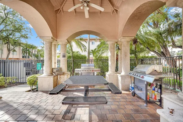 a view of a patio with couches table and chairs and potted plants