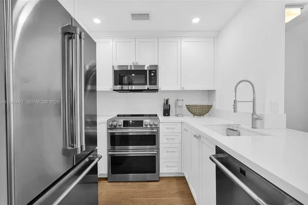 a kitchen with a sink stove and refrigerator