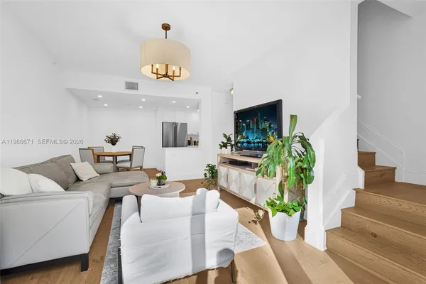 a living room with furniture and a clock