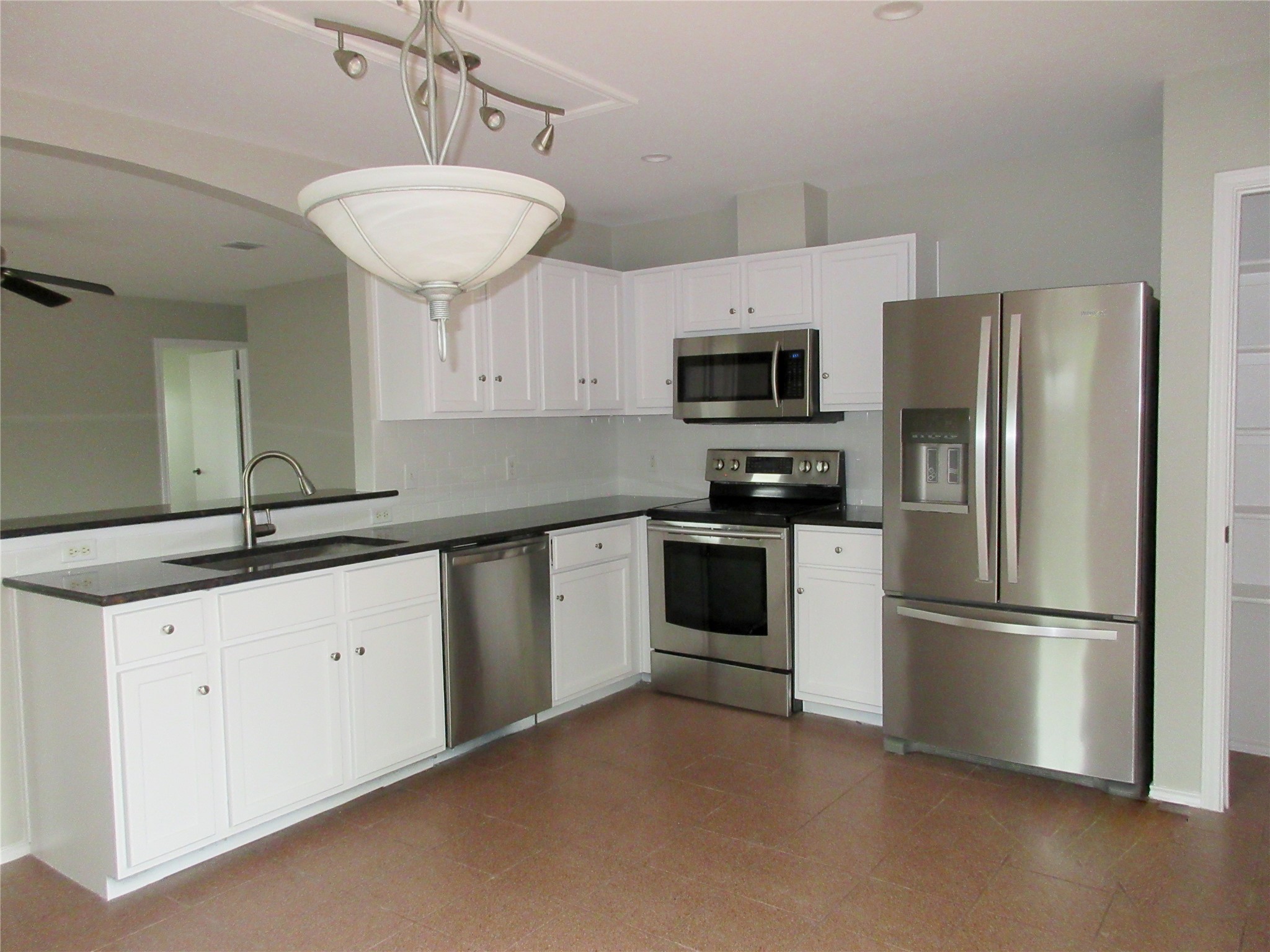 115 Rei Tang Loop Kyle, TX 78640 - Photo 4 of 17 a kitchen with stainless steel appliances a refrigerator sink and microwave