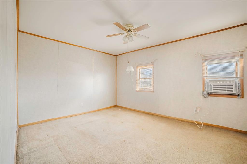 116 10th Street Lucerne Mines, PA 15754 - Photo 11 of 20 an empty room with a ceiling fan and windows