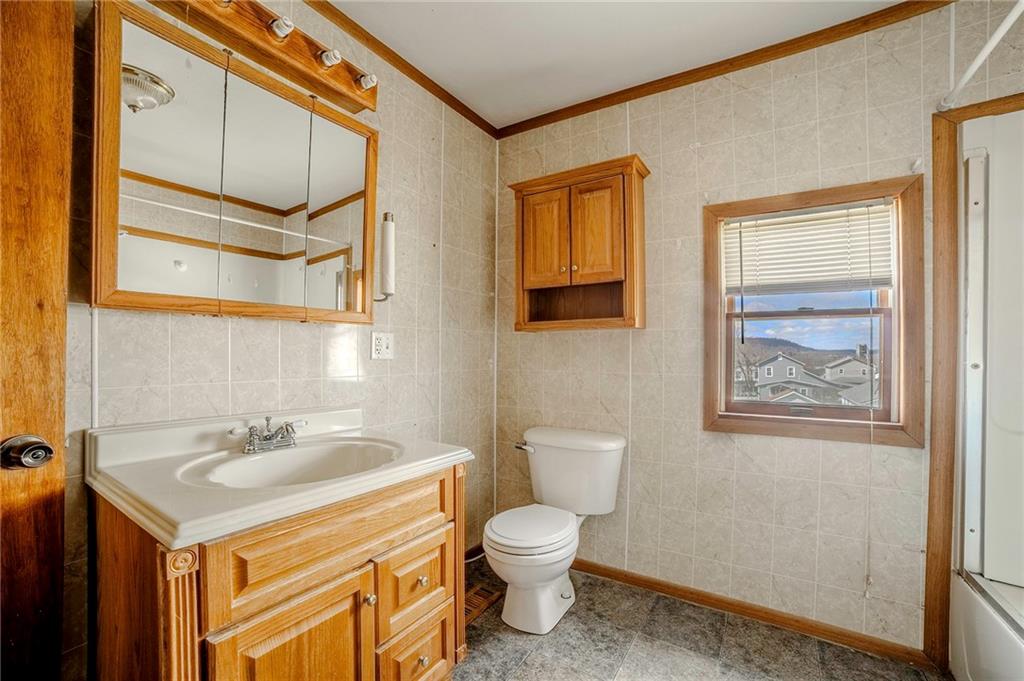 116 10th Street Lucerne Mines, PA 15754 - Photo 12 of 20 a bathroom with a sink a toilet and mirror