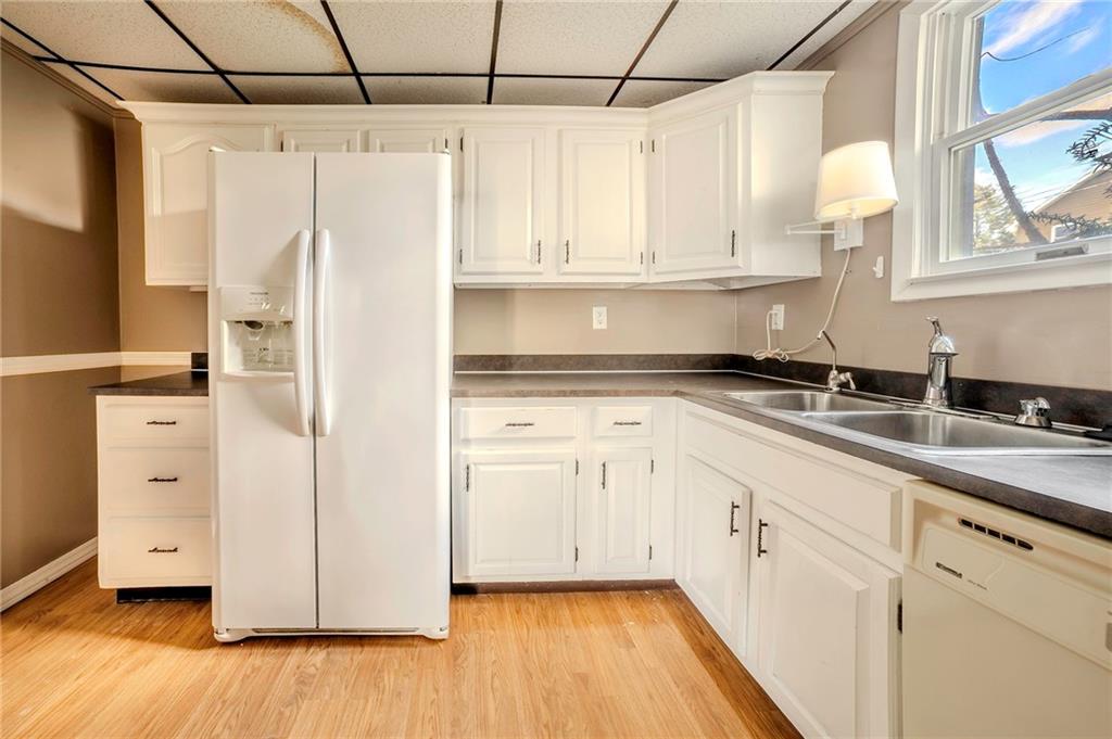 116 10th Street Lucerne Mines, PA 15754 - Photo 7 of 20 a kitchen with stainless steel appliances white cabinets and wooden floor