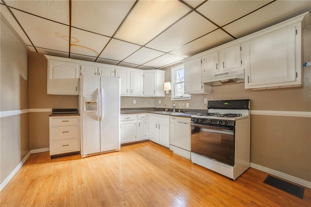 116 10th Street Lucerne Mines, PA 15754 - Photo 9 of 20 a kitchen with stainless steel appliances a stove a sink and white cabinets