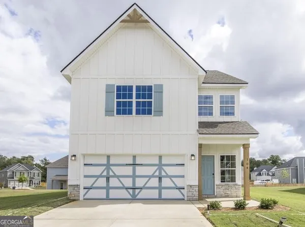 a view of a white house with a yard