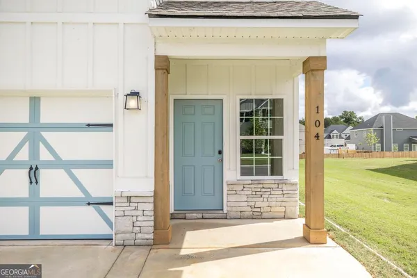 a front view of a house with a garden