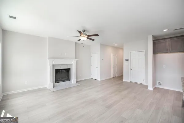 a view of an empty room with a fireplace