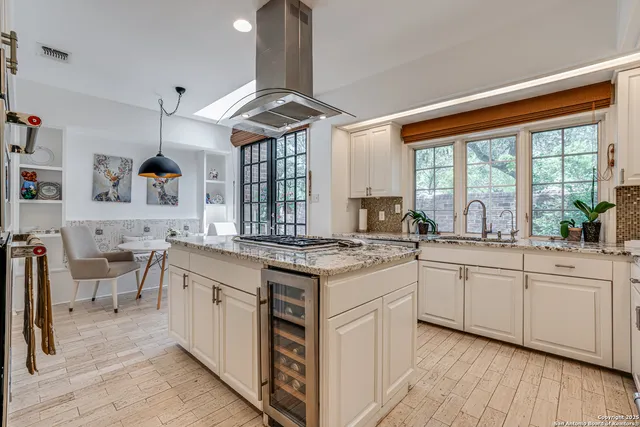 a open kitchen with stainless steel appliances granite countertop a stove and cabinets